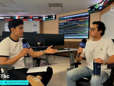 Me and a guest with microphones, recording the Financial Trading Room podcast in front of the market screens